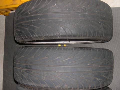 1997 Ford Probe - Two tires and rims are shown stacked, with the tread pattern visible on both.