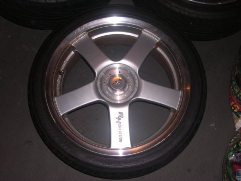 1997 Ford Probe - A single aftermarket wheel with a five-spoke design is shown, visible text on one of its spokes.