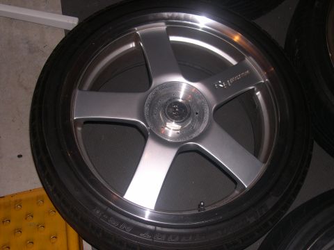 1997 Ford Probe - A single silver five-spoke alloy wheel with a tire is shown, with text visible on the tire sidewall.