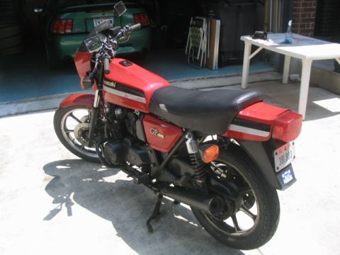 1981 Kawasaki Bayou - A red 1981 Kawasaki GPz 550 motorcycle is parked in a garage, with a green car visible behind it.