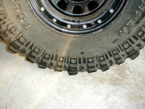 1996 Ford Bronco - A close-up view of an off-road tire and rim, showing the aggressive tread design.