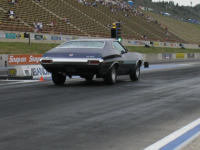 Dark blue 1972 Ford Torino Sport Fastback on drag strip, rear view