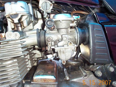 1982 Kawasaki CSR - Close-up view of a motorcycle's engine, focusing on the carburetor and associated fuel lines.