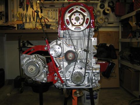 1987 Suzuki Samurai - Engine assembly with timing belt and alternator visible, set up in a workshop.