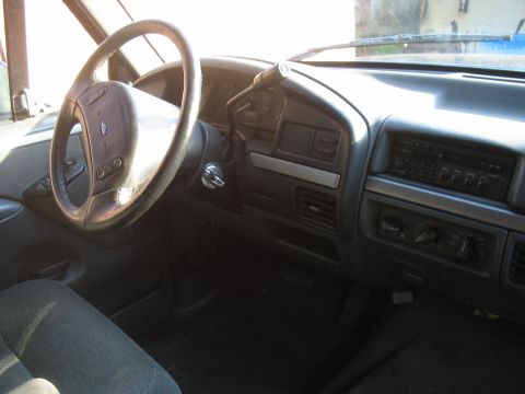 1992 Ford Bronco - The interior of a 1992 Ford Bronco, showing the steering wheel, dashboard, and center console.