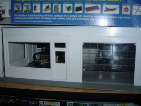 1979 Ford Bronco - A model service station building is shown with a model vehicle parked inside the service bay.