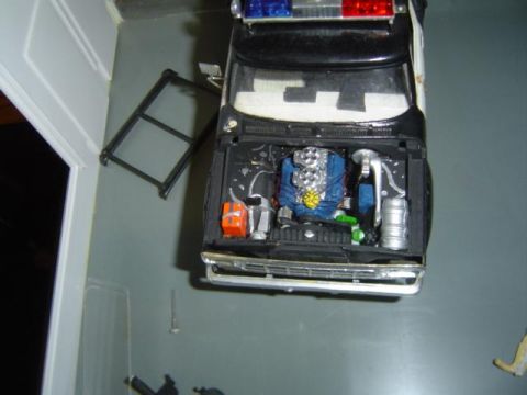 1979 Ford Bronco - Model police car with engine bay details visible, including a blue engine and chrome intake.