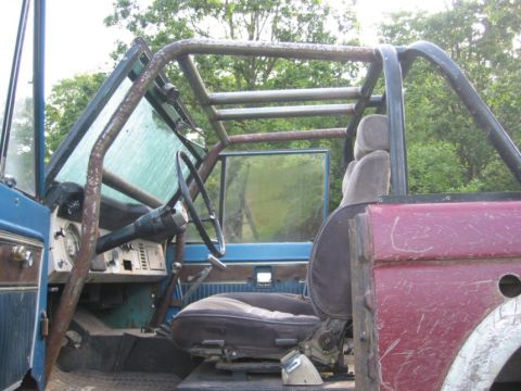 1968 Ford Bronco - Interior view of a 1968 Ford Bronco, showing the dashboard, seats, and a prominent roll cage.