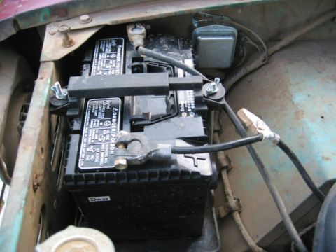 1968 Ford Bronco - Close-up of a vehicle battery and its wiring, showing a date code of April 2007.