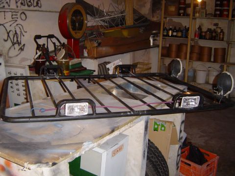 1996 Ford Explorer - A roof rack with auxiliary lighting is shown, mounted above other items in what appears to be a workshop or storage area.