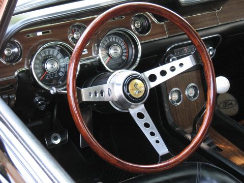 1968 Shelby GT500 - Close-up of the 1968 Shelby GT500 interior, highlighting the woodgrain trim and iconic steering wheel.