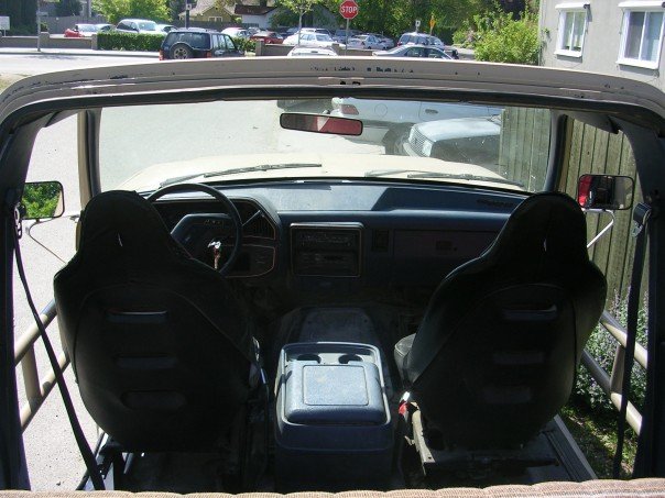 Interior of a beige SUV, showing front seats, dashboard, and center console