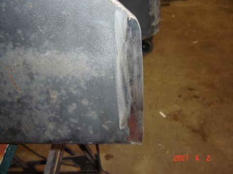1993 Ford Bronco - Detail of a vehicle bumper corner showing wear and repair work.