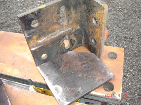 1993 Ford Bronco - A heavily rusted metal bracket with various mounting holes is shown in detail.