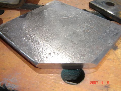 1993 Ford Bronco - A close-up of a metal bracket with a green object visible beneath it.
