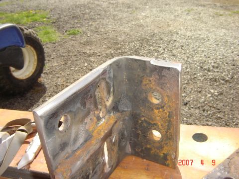1993 Ford Bronco - A heavy-duty metal bracket, possibly a bumper component, is shown up close with visible rust and mounting holes.