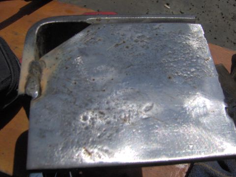 1993 Ford Bronco - This is a metal part that has been welded and shows signs of surface damage.