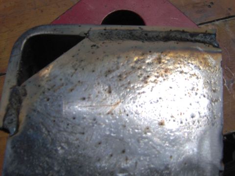 1993 Ford Bronco - This is a close-up view of a corroded metal part, showing signs of wear and welding.