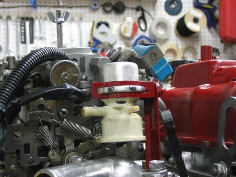1987 Suzuki Samurai - Carburetor assembly with various components and a red mounting bracket.