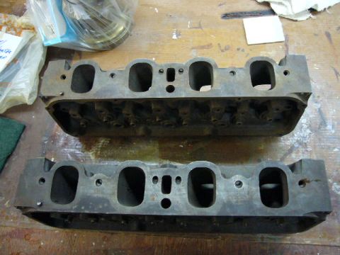 1972 Ford Ranchero - A pair of engine cylinder heads are shown on a workbench, likely for repair or replacement.