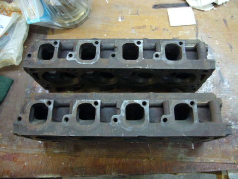 1972 Ford Ranchero - Two engine cylinder heads are shown resting on a workbench, likely awaiting installation or repair.