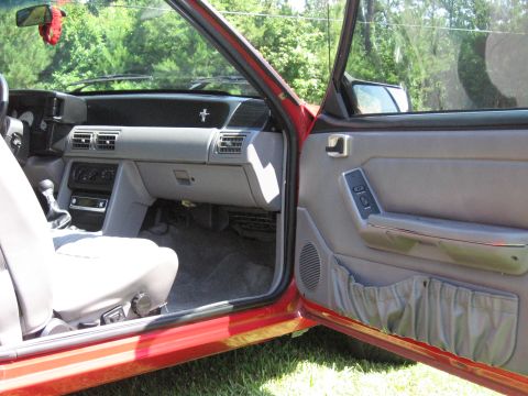 1967 Ford Mustang - Interior view of a red car, likely a 1993 model, with grey upholstery and dashboard details.