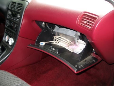 1993 Ford Probe - Interior view of a 1993 Ford Probe, with the glove compartment open revealing electronic equipment and cables.