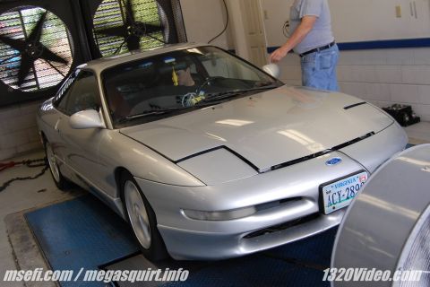 1993 Ford Probe - A silver 1993 Ford Probe is positioned on a dynamometer for testing.