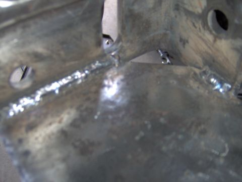1993 Ford Bronco - This is a close-up view of a metal component, likely a chassis part, showing signs of welding and fabrication.