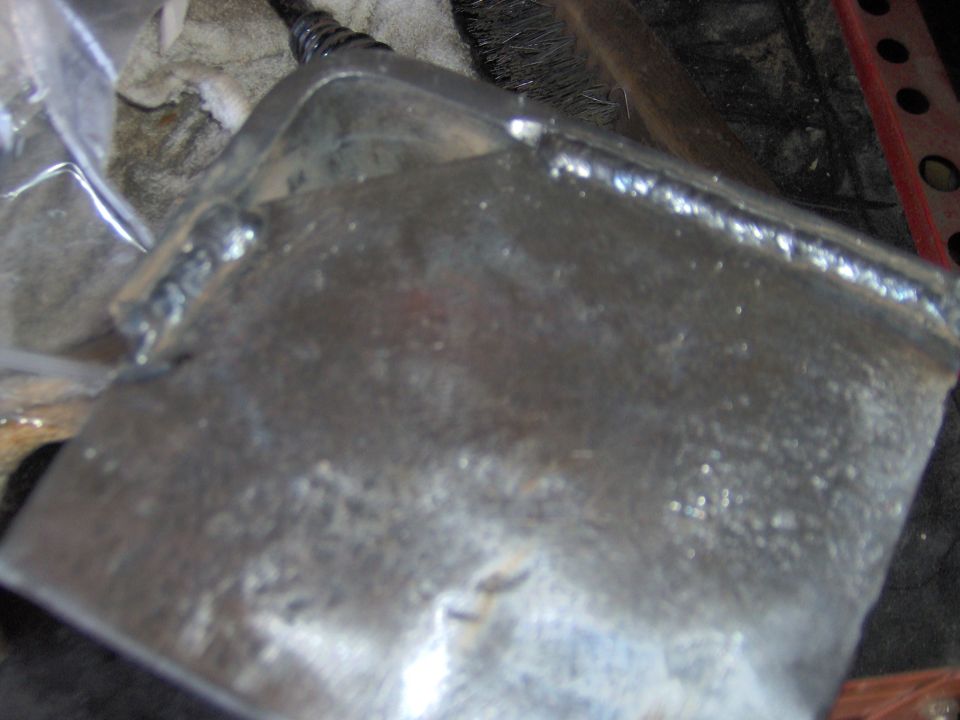 Welded metal part with Supermotors.net logo