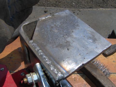 1993 Ford Bronco - Close-up of a freshly welded metal bracket, possibly for automotive repair or fabrication.