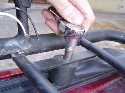 1996 Ford Explorer - A hand tightens a bolt on a vehicle's roof rack assembly.