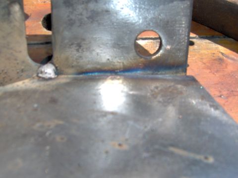 1993 Ford Bronco - Close-up of a metal bracket showing welding and a circular opening, with Supermotors.net watermark.
