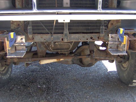 1993 Ford Bronco - Close-up of a vehicle's front axle and suspension components, showing custom bracketry.