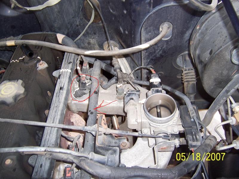 Engine bay with throttle body, sensors, and hoses. Date stamp reads 05/18/2007