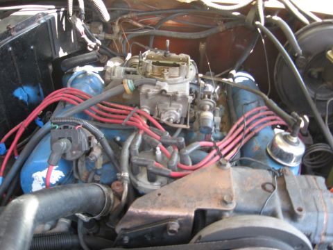 1979 Ford Bronco - Close-up view of an engine bay, showing the carburetor and spark plug wires.