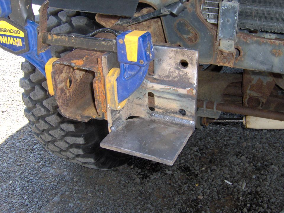 Custom bumper bracket attached with Irwin clamp, showing tire and suspension components