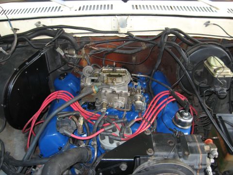 1979 Ford Bronco - A view into the engine bay of a vehicle, showing the engine components and wiring.