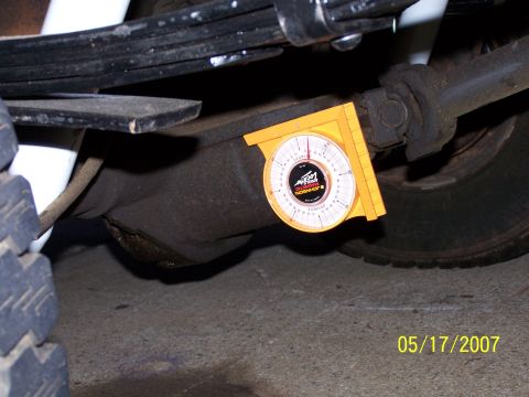 1979 Ford F-150 - An angle gauge is attached to a vehicle's differential housing, likely for alignment purposes.