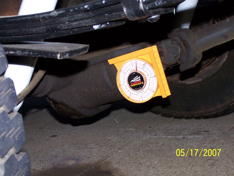 Differential with yellow angle gauge attached to housing