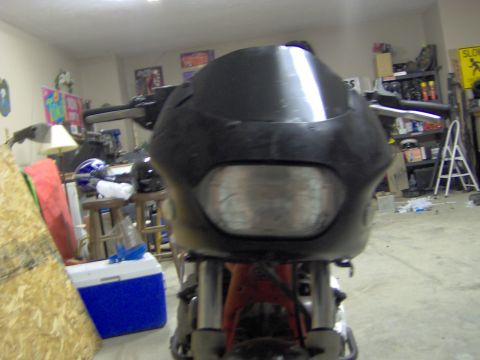 1993 Yamaha Seca II - The front of a motorcycle is shown in a garage, with various items in the background.