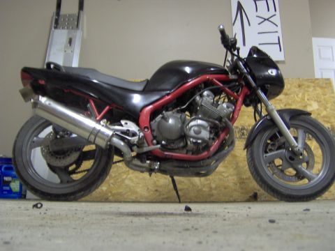 1993 Yamaha Seca II - A black motorcycle with a red frame is parked indoors, with an 'EXIT' sign visible in the background.