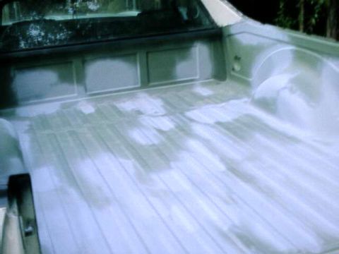 1976 Ford Ranchero - The bed of a pickup truck is shown after primer application, highlighting its construction.