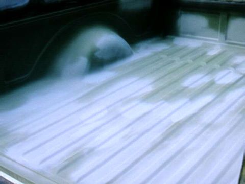 1976 Ford Ranchero - The interior of a truck bed is shown with a fresh white spray-on liner applied.