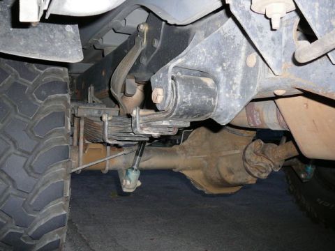 1988 Ford Bronco - Close-up view of the rear leaf spring suspension and axle assembly of a truck.
