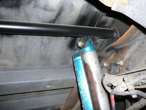 1988 Ford Bronco - The image shows a close-up view of the rear suspension, blue off-road shocks and a sway bar.