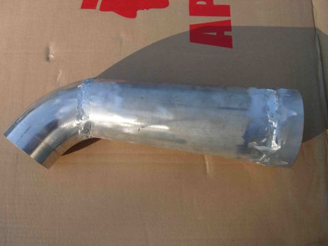 1997 Lincoln Town Car - A metal intake tube with visible welds is shown against a cardboard background.