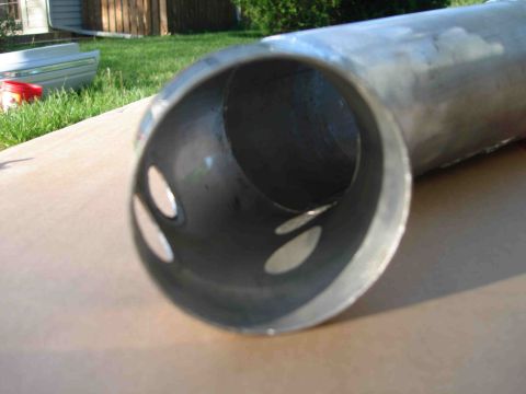 1997 Lincoln Town Car - This metal pipe, possibly an exhaust component, has several oval-shaped openings visible from the end.