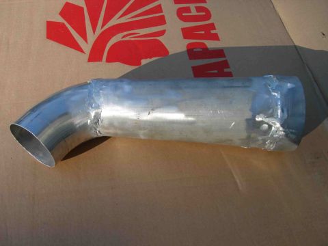 1997 Lincoln Town Car - A metal pipe, likely an air intake component, is shown against a cardboard background with partial text and a red graphic.