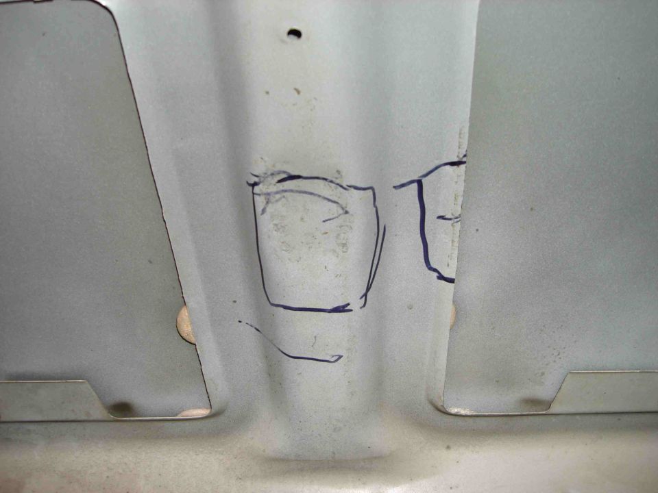 Ribbed gray sheet metal panel with blue marker layout rectangles and cutouts